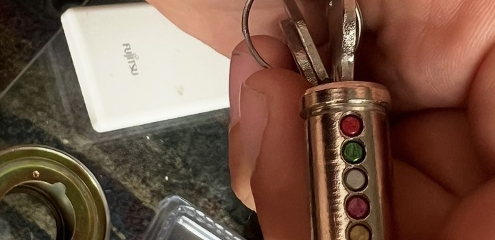 Locksmith holding a pinned lock cylinder during a rekey